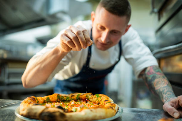 istock Pizza chef preparing pizza at the restaurant. 2201805733