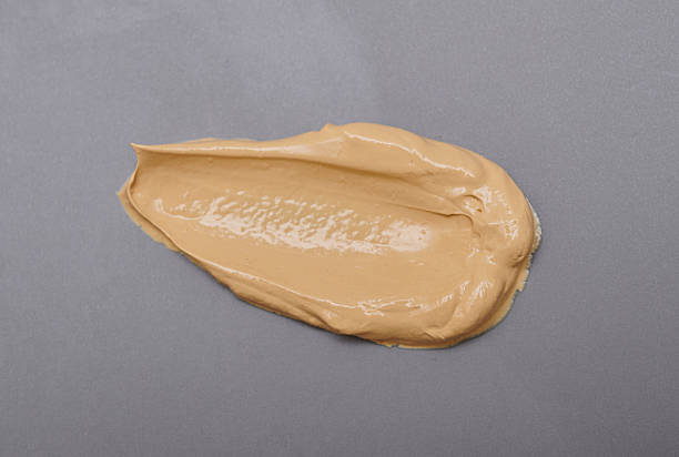 istock Light pale brown yellow gold color cosmetic cream texture 2201810449