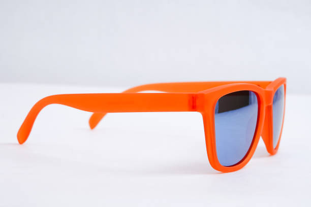Isolated Vibrant Orange Sunglasses Blue Lens White Background for commercial use
