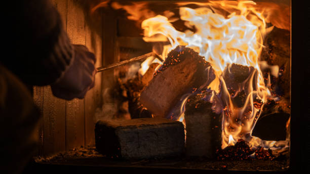 istock Eco-friendly compressed wood briquettes ignite a warm, inviting fire in a modern stove, showcasing sustainable heating and cozy ambiance for any home 2201812185