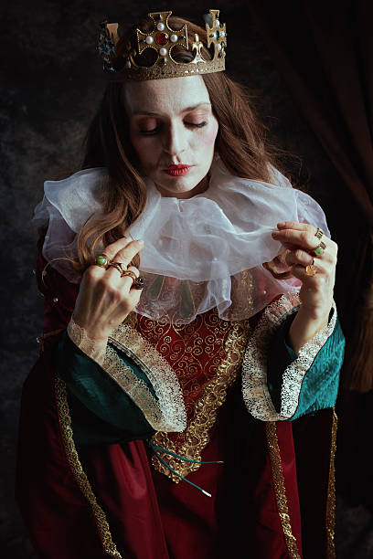 istock medieval queen in red dress with white collar and crown 2201813017