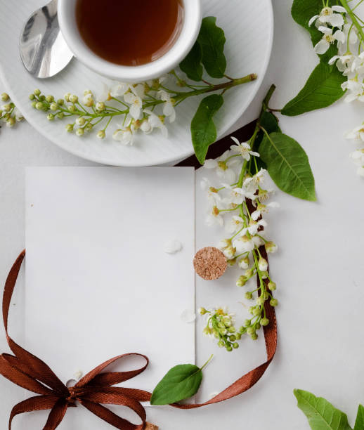 istock Relaxing tea experience with a cup of herbal tea and fresh blossoms on a serene white table setting during springtime 2201815095