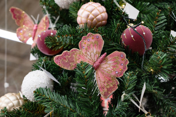 istock Decorative pink butterfly on a Christmas tree. 2201815110