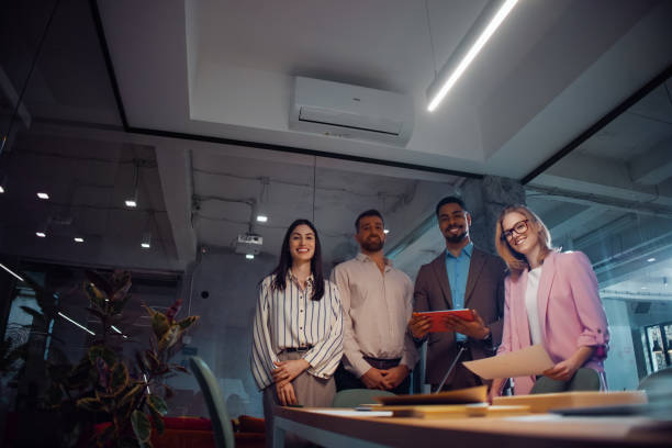 istock Diverse Group of Professionals Standing Together in a Modern Workplace 2201815497