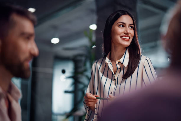 Business Team Meeting with Smiling Woman in Modern Office Setting