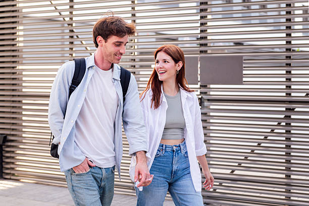 istock man and woman walking together holding hands 2201816080