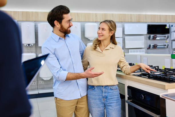 istock A Young Couple Interacting and Exploring Kitchen Appliances in a Modern Showroom Environment 2201816104
