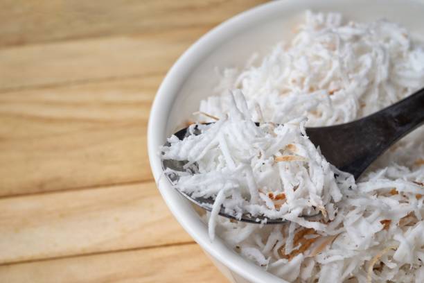 istock Shredded coconut on wood background 2201818301