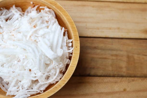 istock Shredded coconut on wood background 2201818320