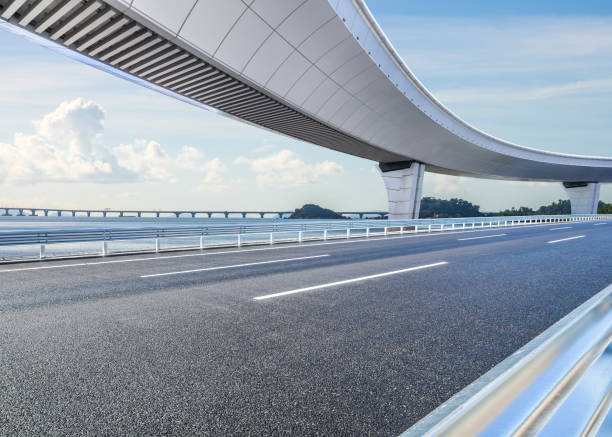 istock Asphalt road and bridge with beautiful coastline scenery under blue sky 2201821133