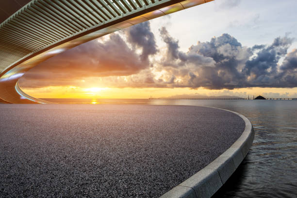 istock Asphalt road and bridge with beautiful coastline scenery at sunset 2201821194