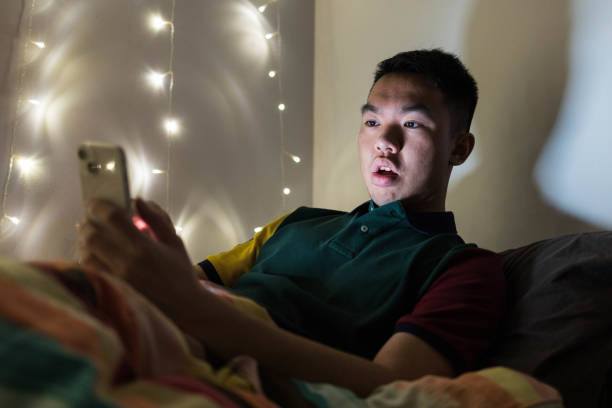 istock A young teenager using his phone on his bed at night 2201821798