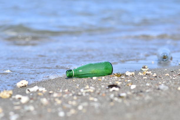 istock green glass bottles on the beach 2201825033