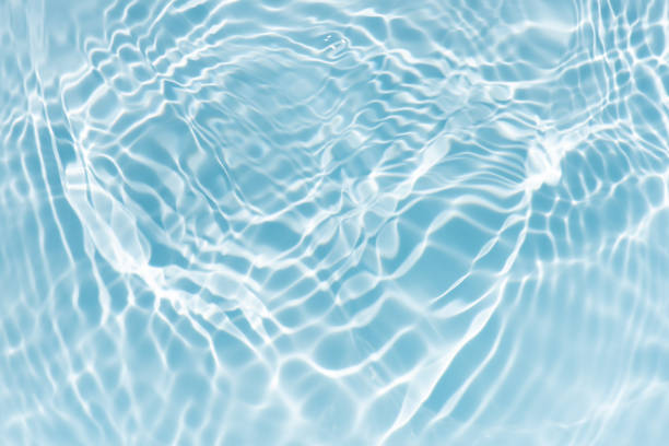 istock Blue water with ripples on the surface. Defocus blurred transparent blue colored clear calm water surface texture with splashes and bubbles. Water waves with shining pattern texture background. 2201826869