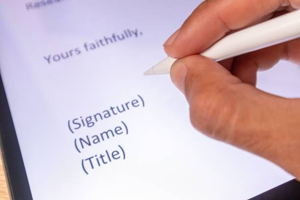 istock Hand holding a stylus pen for electronic signature on computer tablet 2201830956