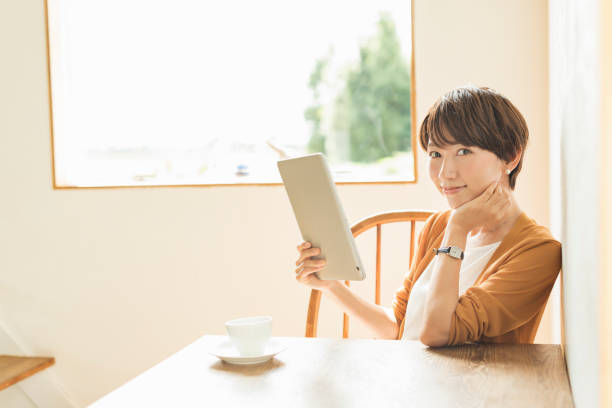 istock Woman working on a tablet at a cafe 2201832279