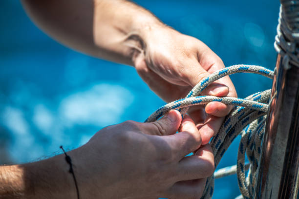 istock Securing the Sail: Tying Ship Rope and Knot on a Sail 2201833220