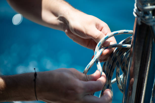 istock Securing the Sail: Tying Ship Rope and Knot on a Sail 2201833809