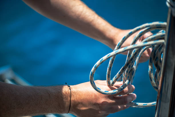 istock Securing the Sail: Tying Ship Rope and Knot on a Sail 2201834135