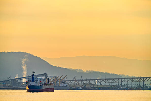 Sunrise view of a freighter ship docked in the Vancouver Burrard Inlet harbor, British Columbia