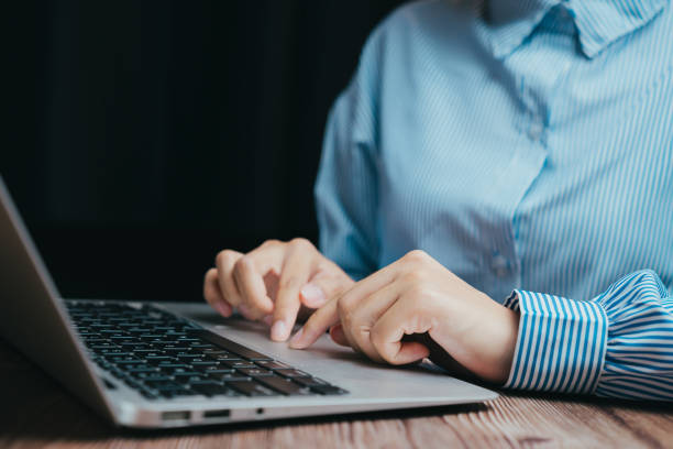 istock Close-Up of Hands Typing on Laptop Keyboard in Dim Light Setting, Business concept 2201837921