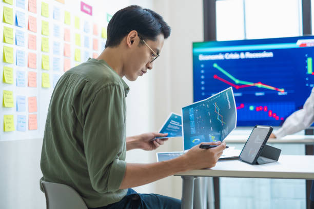 istock team of finance  get stress when analyzing economic crisis data and recession impacts during meeting in a office 2201838196