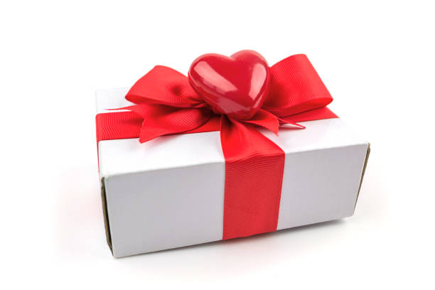 istock White gift box with a red ribbon and a red heart on a white background. 2201838375