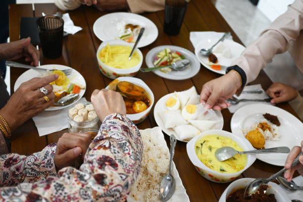 istock Close up of hand eating in dinner table together 2201838718