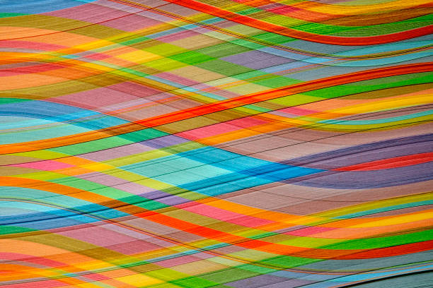 Close-up of multicolored paper curved stripes abstract forming background.