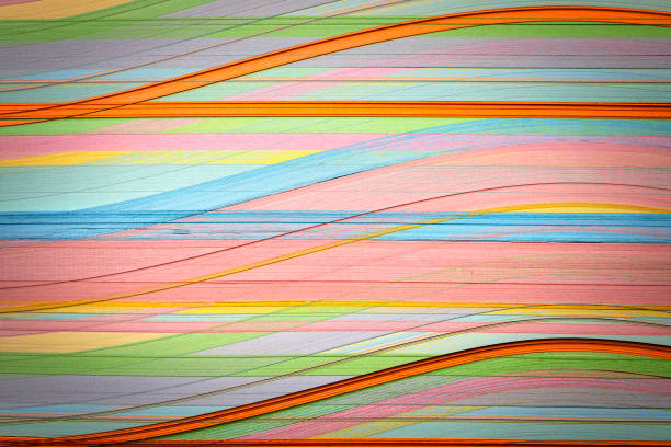 istock Multicolored paper curved stripes abstract forming background 2201840124