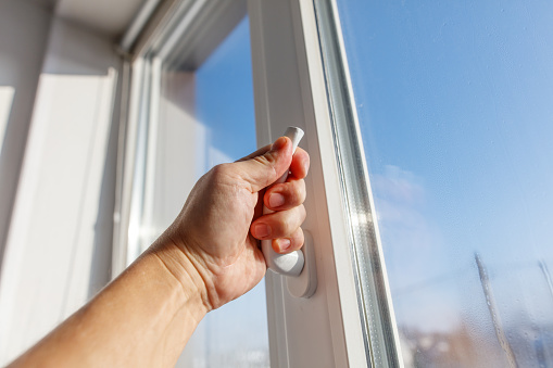 Window Hand Grip A Hand Is Holding A Window Handle And The Window Is Open Stock Photo ...