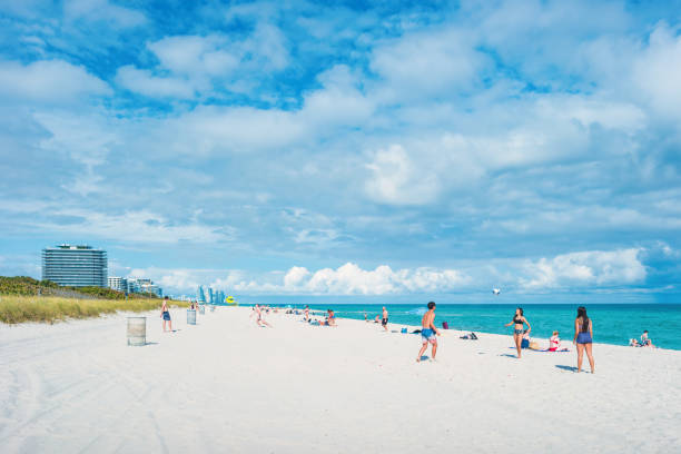 People enjoy the beach in Miami Beach, Florida, USA on a cloudy day.