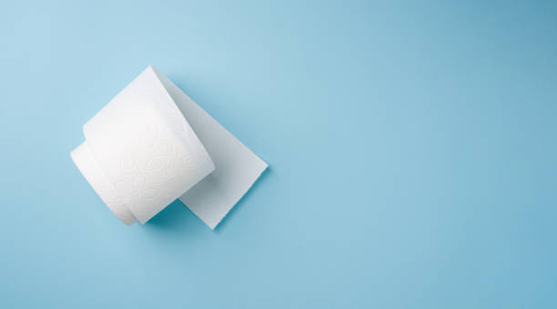 istock Top view of toilet paper roll on blue background 2201845645