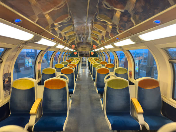 Paris,France-21.02.2025 Brightly lit train carriage features an array of colorful seating and a spacious layout. Enjoys peaceful ambiance as the cityscape glimmers outside the windows.
