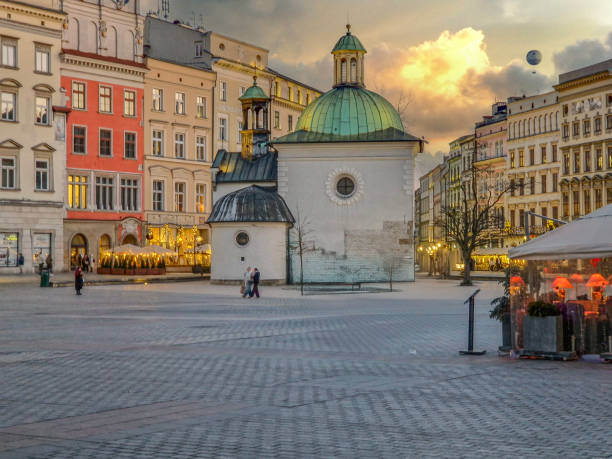 view of a fortress in Warsaw's old town with colorful buildings in the background and a bare tree on a winter day