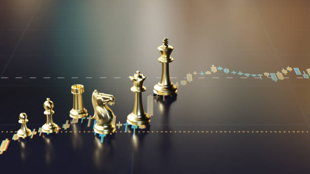 istock Gold Chess Pieces on Financial Chart Representing Strategy and Market Growth 2201848173