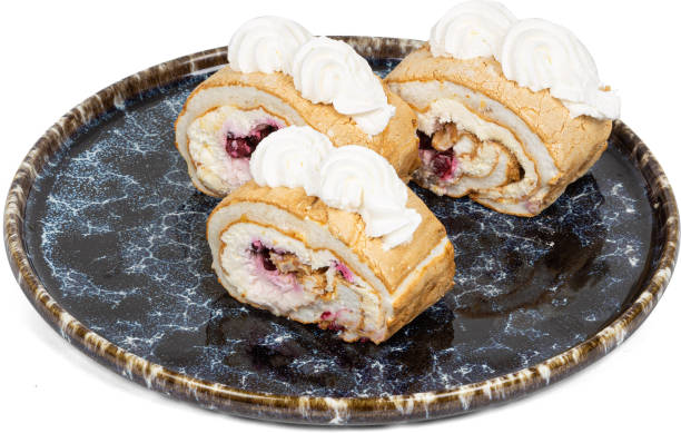 istock Three tasty cake pieces on a black plate, topped with cream 2201848289