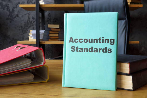 istock Accounting standards book in an office. Financial compliance. 2201849300