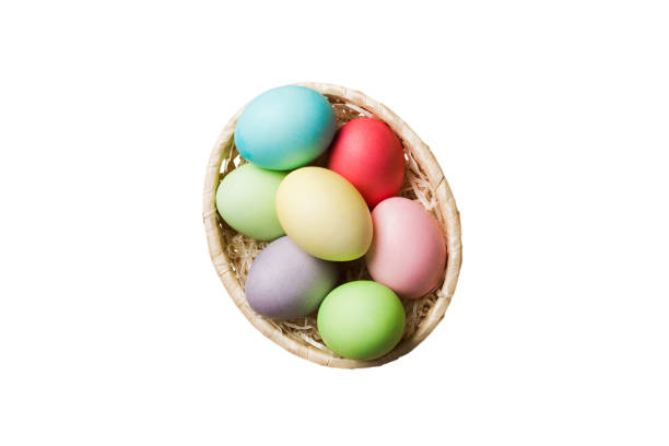 istock Basket of colorful Easter eggs isolated on white background. Easter basket filled with colored eggs top view holiday concept 2201849733