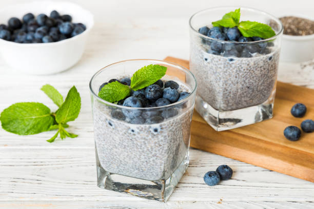 istock Healthy breakfast or morning with chia seeds vanilla pudding and blueberry berries on table background, vegetarian food, diet and health concept. Chia pudding with coconut milk and blueberry 2201849815