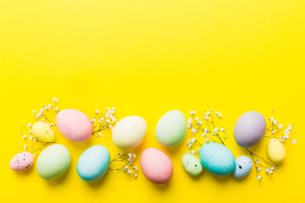 istock Happy Easter composition. Easter eggs on colored table with gypsophila. Natural dyed colorful eggs background top view with copy space 2201849840
