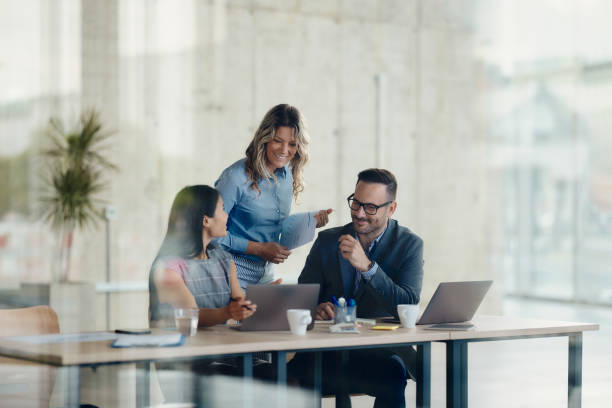 istock Happy business team working on laptop in the office. 2201850207