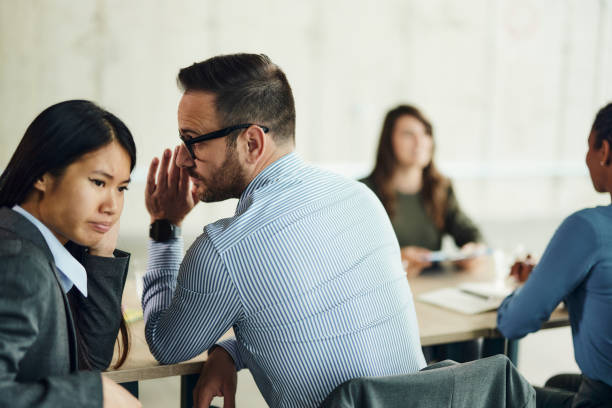 Human resource team whispering on a job interview.