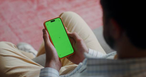 istock A phone with a green screen in men's hands 2201850386