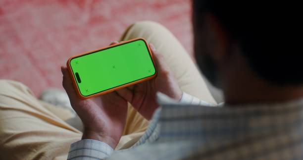istock A phone with a green screen in men's hands 2201850389