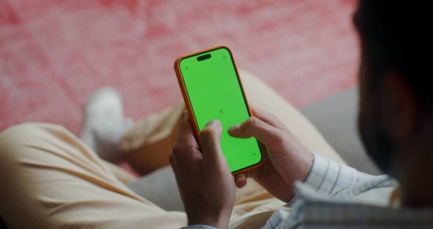 istock A phone with a green screen in men's hands 2201850397
