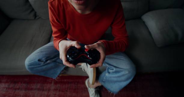 istock A woman plays video games at home 2201850918