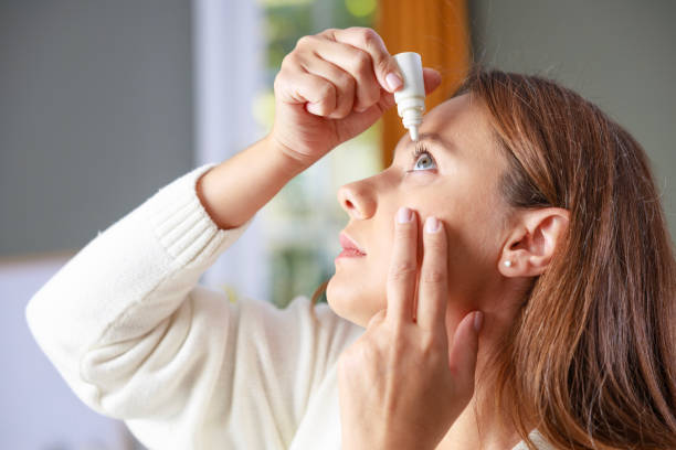 istock Young woman putting eye drops 2201852365
