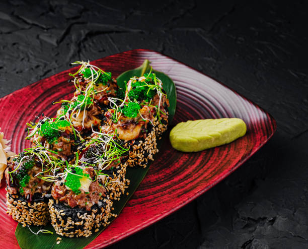 istock Gourmet sushi rolls topped with fresh ingredients set on a stylish plate 2201852838