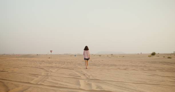 istock A woman walks in the desert 2201853225